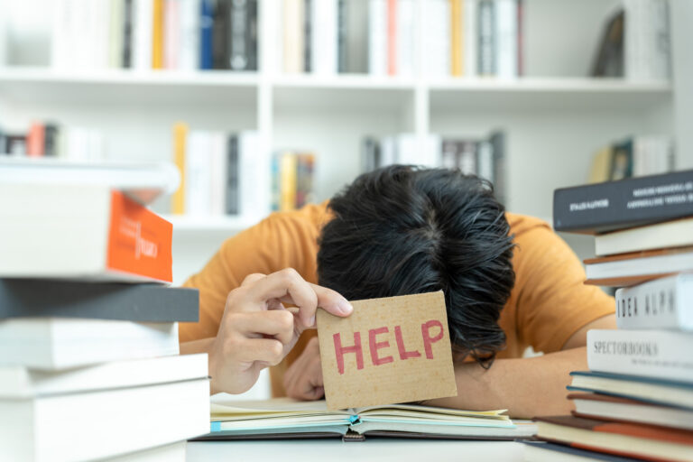 Asian student man have anxiety because of exams, male prepare for test and learning lessons in the library. stress, despair, haste, misunderstanding reading, discouraged, expectation, knowledge, tired